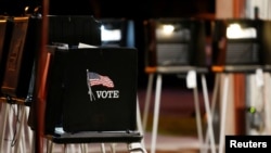 FILE - A voting booth is seen at a polling center inside a fire station during the Democratic presidential primary election in Miami, Florida, March 17, 2020. 