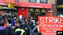 A coalition of groups rally in front of a McDonald's on East 125th Street and Lexington Avenue in Harlem during a protest by fast food workers and supporters for higher wages in New York, Apr. 4, 2013.