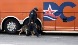 A US Capitol police K-9 unit officer check a bus waiting to enter the U.S. Capitol in Washington, D.C., on March 4, 2021.