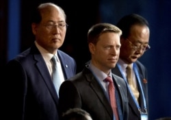 FILE - Matt Pottinger, center, then-Special Assistant to U.S. President Donald Trump and National Security Council (NSC) Senior Director for East Asia, attends an event in Beijing, May 14, 2017.