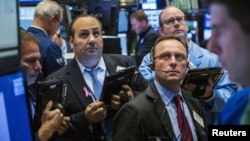 Traders work on the floor of the New York Stock Exchange shortly after the opening bell in New York, October 28, 2015. 