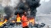 A Somali man protests against the killing Friday night of two people during an overnight curfew, intended to curb the spread of the new coronavirus, on a street in Mogadishu, Somalia, April 25, 2020.
