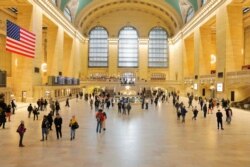 Commuters walk through the lobby of Grand Central Station in New York, March 12, 2020.