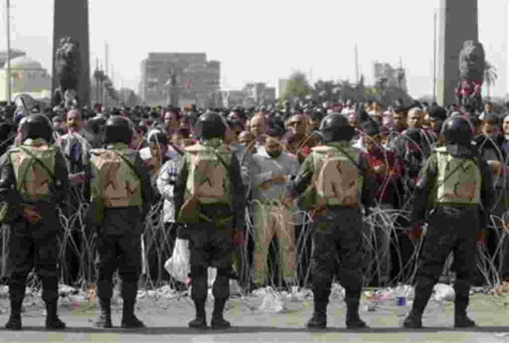 Egyptian protesters perform Friday prayers during a protest in Tahrir or Liberation Square in Cairo, Egypt Friday, Feb. 4, 2011. Protesters demanding President Hosni Mubarak's ouster packed Cairo's central square by the tens of thousands Friday, waving Eg