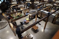 An employee cleans the floor at Riverside Market in Christchurch on May 14, 2020. New Zealand will phase out its coronavirus lockdown over the next 10 days after successfully containing the virus.