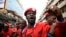 FILE - Musician turned politician Robert Kyagulanyi, aka Bobi Wine, is joined by other activists in Kampala, July 11, 2018. Kyagulanyi was among the opposition legislators who were arrested Monday, then reportedly tortured by security forces.