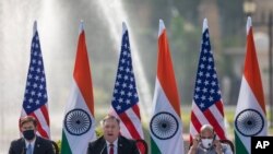 U.S. Secretary of State Mike Pompeo, center, speaks as Secretary of Defence Mark Esper, left, and Indian Defence Minister Rajnath Singh sit beside him during a joint press conference at Hyderabad House in New Delhi, India, Tuesday, Oct. 27, 2020…
