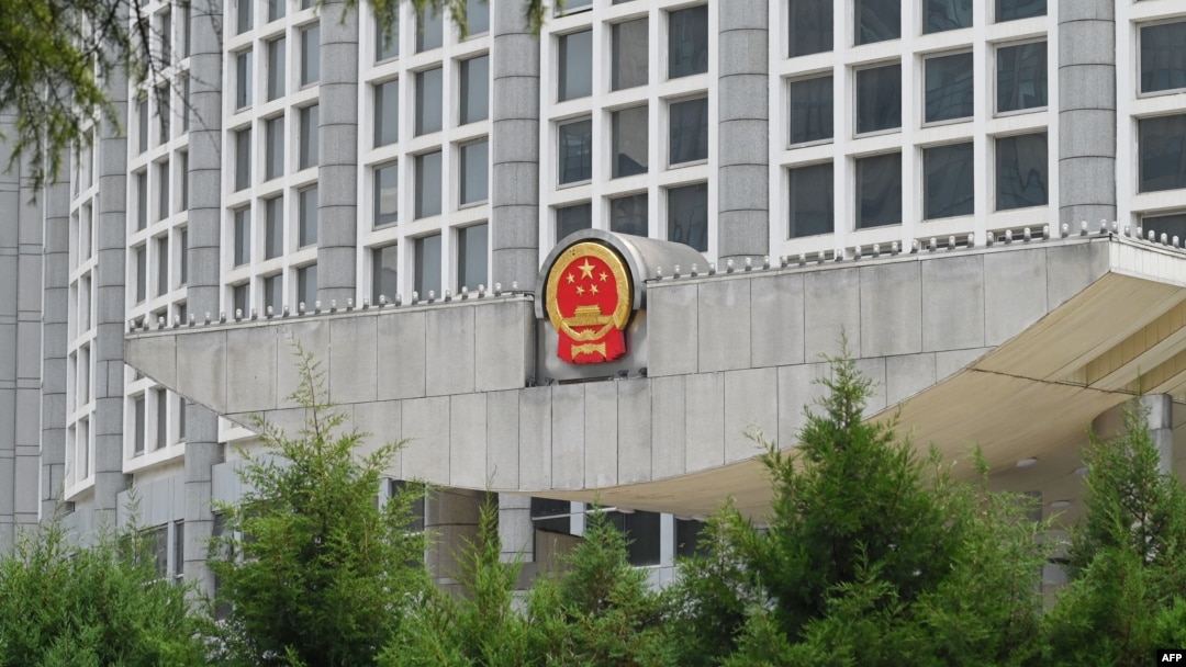 FILE - China's national emblem is seen on the Ministry of Foreign Affairs building in Beijing, July 26, 2023.