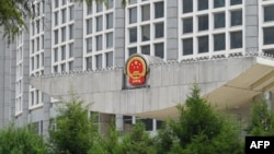 FILE - China's national emblem is seen on the Ministry of Foreign Affairs building in Beijing, July 26, 2023.