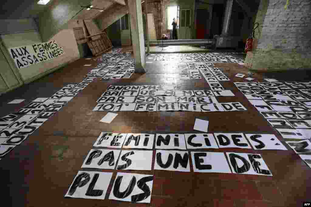 Banners, dedicated to the memory of women killed by their current or former partner and against violence toward women, are seen in an artist squat in Paris.