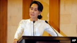 Myanmar State Counsellor Aung San Suu Kyi speaks at a memorial ceremony to mark one month from the killing of Ko Ni, prominent legal adviser to the government, and taxi driver Ne Win, Feb.26, 2017, in Yangon, Myanmar. 