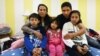 FILE - Jeanette Vizguerra (2-L) poses with her husband Salvador Baez (2n-R) and their children in the First Unitarian Society Church of Denver, in Denver, Colorado, Feb. 16, 2017. The family, undocumented immigrants, had taken refuge in the church for fear of being deported by Immigration and Customs Enforcement.