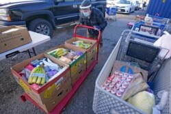 Pantry manager Ken Donovan loads food into cars outside Catholic Community Services of Utah, Nov. 20, 2020, in Ogden, Utah. As coronavirus concerns continue, the need for assistance has increased.