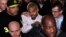 Singer Chris Brown (C) leaves the U.S. District Court in Washington, Oct. 28, 2013. 