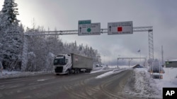 FILE - A truck passes the Norwegian border toward Sweden on Feb. 8 2019. Norway announced on Oct. 12, 2024, that it is instituting temporary border checks until Oct. 22 because its terror threat level was recently raised.