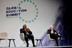 Kenya's President Uhuru Kenyatta and Britain's Prime Minister Boris Johnson applaud during the closing ceremony on the second day of the Global Education Summit in London, Britain, July 29, 2021.