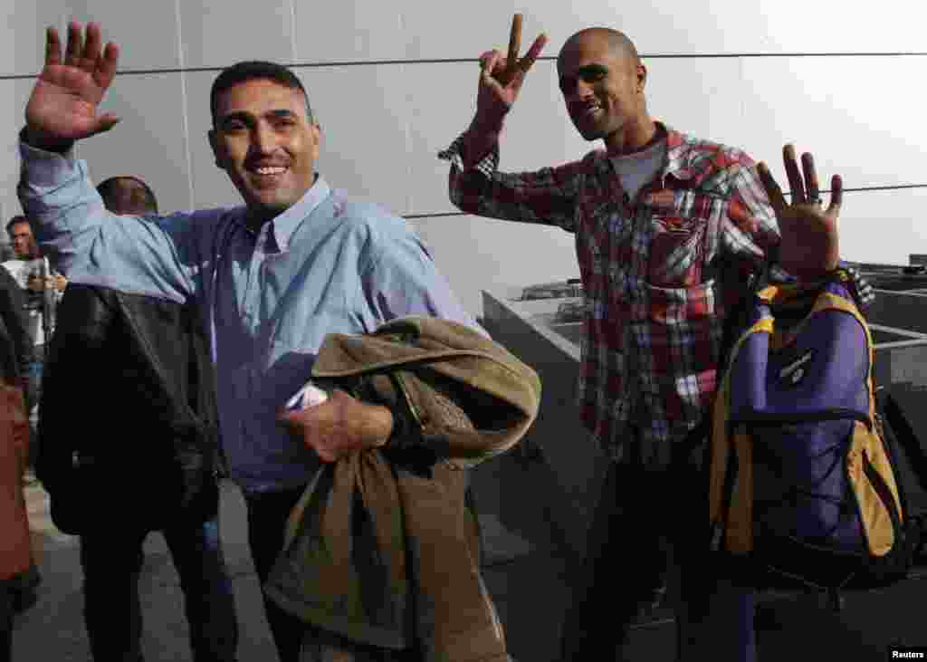 Fatah movement activists wave upon arriving at the Rafah border crossing in the southern Gaza Strip December 3. 