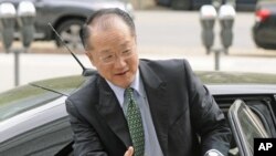 New head of the World Bank and former Dartmouth College president, Jim Yong Kim, reaches out to shake hands as he arrives for meetings at the bank's headquarters in Washington, April 11, 2012.