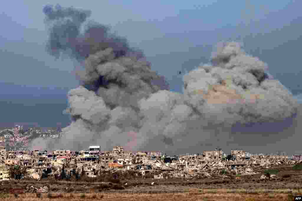 This picture taken from the Israeli side of the border with the Gaza Strip shows smoke plumes rising from explosions above destroyed buildings in the northern Gaza Strip, amid the ongoing war between Israel and Hamas.