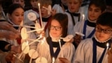 Choristers light candles during a rehearsal for Christmas services at St. Paul's Cathedral in London, Britain, Dec. 23, 2024. St. Paul's choir includes girls for the first time in its 900-year history. 