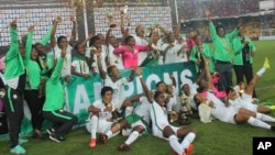 FILE - Nigeria soccer players celebrate after they won the final game of the Women's Africa Cup of Nations against Cameroon, at Ahmadou Ahidjo Stadium in Yaounde, Cameroon, Dec. 3, 2016