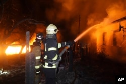 Firefighters extinguish a fire after a Russian attack on a residential neighborhood in Kharkiv, Ukraine, on Feb. 10, 2024. City officials said at least 14 homes were destroyed.