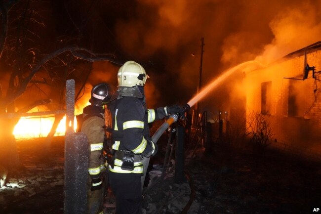 Firefighters extinguish a fire after a Russian attack on a residential neighborhood in Kharkiv, Ukraine, on Feb. 10, 2024. City officials said at least 14 homes were destroyed.
