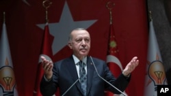 Turkey's President Recep Tayyip Erdogan speaks to his ruling party officials, in Ankara, Turkey, Oct. 10, 2019. 