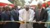 Cameroonian Prime Minister Philemon Yang cuts the symbolic ribbon at the inauguration of the Public Health Emergency Operations Center, in Yaounde, Cameroon, Dec. 3, 2018. (M. Kindzeka/VOA)