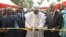 Cameroonian Prime Minister Philemon Yang cuts the symbolic ribbon at the inauguration of the Public Health Emergency Operations Center, in Yaounde, Cameroon, Dec. 3, 2018. (M. Kindzeka/VOA)