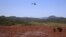 FILE - A helicopter flies over the Bento Rodrigues district, covered with mud after a dam owned by Vale SA and BHP Billiton Ltd. burst in Mariana, Brazil, Nov. 6, 2015. 