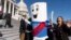 FILE - A man dressed as "Build Back Better Bill" wears a sash saying, "On to the Senate," Nov. 19, 2021, on Capitol Hill.