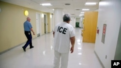 FILE - An inmate facing deportation to El Salvador returns to his cell during detainment by Immigration and U.S. Customs Enforcement, in the Suffolk County House of Correction in Boston, Massachusetts, Sept. 1, 2017.