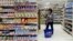 FILE - A woman shops at a supermarket in Cairo, Egypt. 