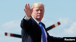 U.S. President Donald Trump waves as he boards Air Force One at Joint Base Andrews outside Washington, before traveling to Bedminister, N.J., for the weekend, June 9, 2017.