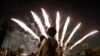 Visitors watch fireworks at Toshimaen amusement park in Tokyo, Japan.