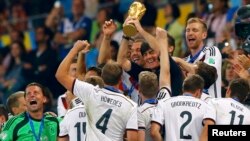 Para pemain Jerman merayakan gelar juara Piala Dunia ke-4 setelah menaklukkan Argentina 1-0 dalam pertandingan di stadion Maracana, Rio de Janeiro, Brazil, Minggu (13/7).