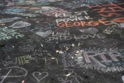 Handwritten messages can be seen at a memorial for George Floyd that has been created at the place where he was taken into police custody and later died in Minneapolis, Minnesota, June 1, 2020.
