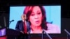 FILE - An image of Democratic presidential nominee Kamala Harris is shown as the Republican presidential nominee, former U.S. President Donald Trump, campaigns in Detroit, Michigan, Oct. 18, 2024.