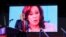 FILE - An image of Democratic presidential nominee Kamala Harris is shown as the Republican presidential nominee, former U.S. President Donald Trump, campaigns in Detroit, Michigan, Oct. 18, 2024.