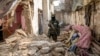 FILE - A Taliban fighter checks remnants of an alleged Islamic State group hideout which the Taliban said it destroyed as part of operations targeting IS militants, in Kabul, Afghanistan, Feb. 14, 2023.