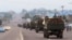 FILE - Military trucks carrying Congolese troops drive down a main street after violence erupted due to the delay of presidential elections, in Kinshasa, Democratic Republic of Congo, Sept. 20, 2016.