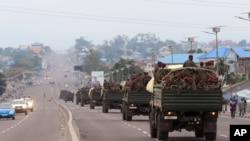 Congo military trucks carrying Congolese troops drive in a main street after violence erupted due to the delay of the presidential elections in Kinshasa, Democratic Republic of Congo, Tuesday, Sept. 20, 2016.