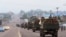 FILE - Congo military trucks carrying Congolese troops drive in a main street after violence erupted due to the delay of the presidential elections in Kinshasa, Democratic Republic of Congo, Sept. 20, 2016.