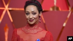 Ruth Negga, wearing the ACLU ribbon, arrives at the Oscars on Sunday, Feb. 26, 2017, at the Dolby Theatre in Los Angeles. 