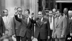 FILE - President Jimmy Carter, center left, and Soviet President Leonid Brezhnev, center right, outside the U.S. Embassy after both heads of state finished their first round of talks prior to the Salt II Treaty signing, June 16, 1979, in Vienna, Austria. (AP Photo/File)