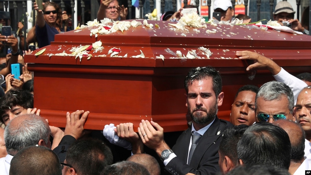 Alan Raul Garcia, son of Peru's late President Alan Garcia, carries the coffin of his father during the funeral procession in Lima, Peru, April 19, 2019. 
