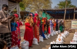 Rohingya refugees collect food from a community charitable organization in Faridabad, Haryana, India, in early 2024.