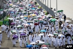 Muslim pilgrims arrive at the Mina tent camp during the annual Hajj pilgrimage near Mecca, Saudi Arabia, on June 14, 2024. Saudi health officials have warned that temperatures could reach 48 Celsius (118 Fahrenheit).
