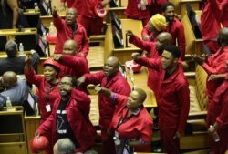 Members of the Economic Freedom Fighters (EFF) party disrupt parliament proceedings at the State of the Nation Address in Cape Town, South Africa, Feb. 13, 2020.